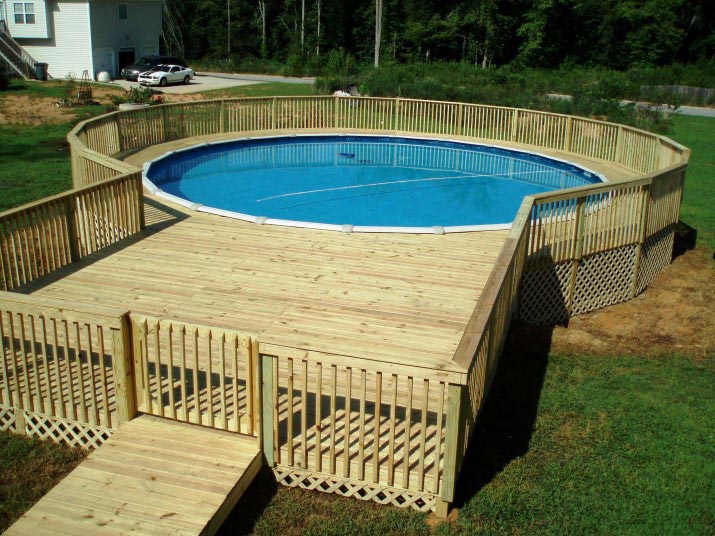 Swimming pool with both wooden deck and fence