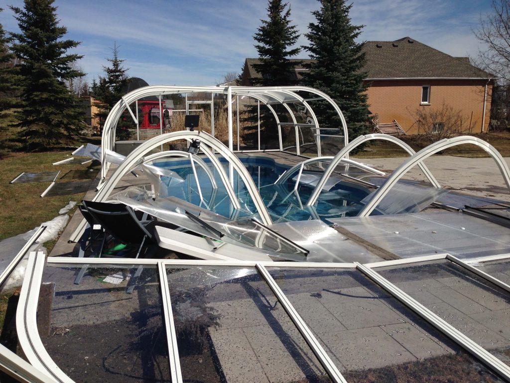 Collapsed swimming pool enclosure